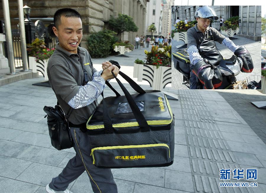 Wang delivers goods to the Bund in Shanghai on July 3, 2013. Wang, 32, from Anhui province, works as a delivery man. Shanghai issued yellow warning of high temperature on July 3, 2013. The maximum temperature exceeded 35 degrees Celsius. (Xinhua/Ding Ding) 