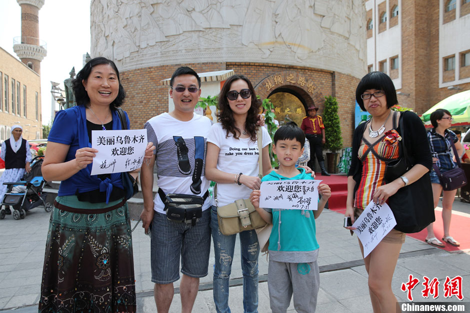 Tourists from Zhejiang Province pose for a photo at International Grand Bazaar in Urumqi, capital city of northwest China's Xinjiang Uygur Autonomous Region. (Photo provided by netizens)