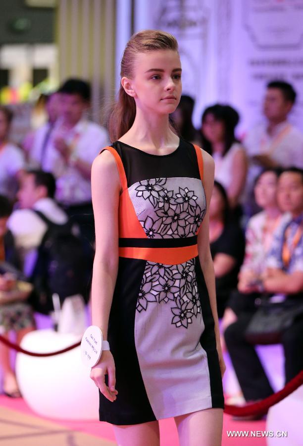 A model presents a creation of a brand at the 20th Hong Kong Fashion Week for Spring/Summer in south China's Hong Kong, July 10, 2013. The four-day fair, which is organized by the Hong Kong Trade Development Council, kicked off at the Hong Kong Convention and Exhibition Center Monday. (Xinhua/Li Peng)