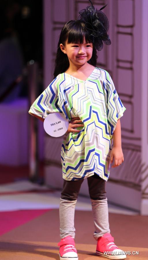 A model presents a creation of a brand at the 20th Hong Kong Fashion Week for Spring/Summer in south China's Hong Kong, July 10, 2013. The four-day fair, which is organized by the Hong Kong Trade Development Council, kicked off at the Hong Kong Convention and Exhibition Center Monday. (Xinhua/Li Peng)