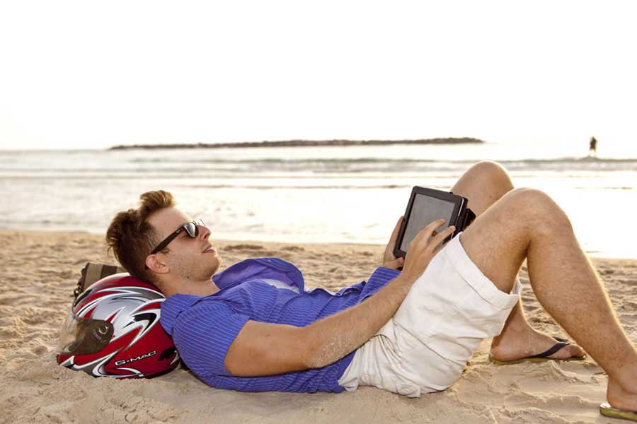 A man enjoys free WiFi on the beach in Tel Aviv-Yafo on Tuesday, July 9, 2013. [Photo courtesy of Kfir Bolotin]