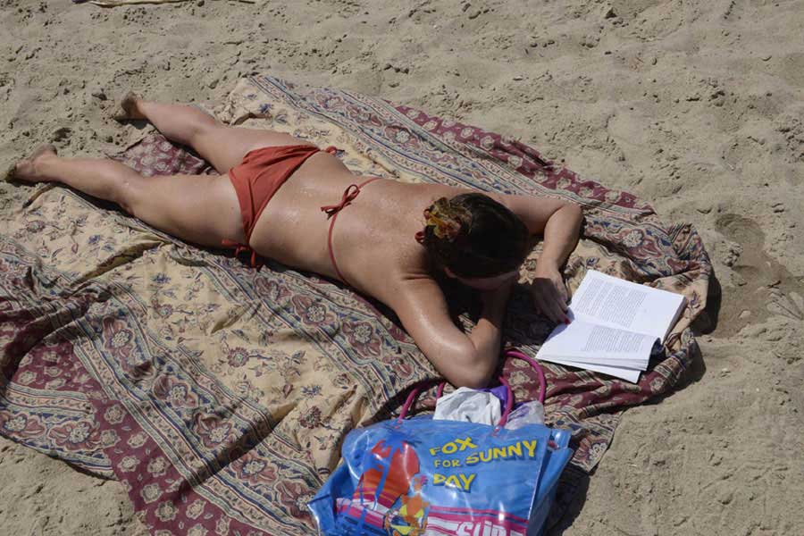 A woman reads a book on the beach in Tel Aviv-Yafo on Tuesday, July 9, 2013. [Photo courtesy of Malovani Israel]