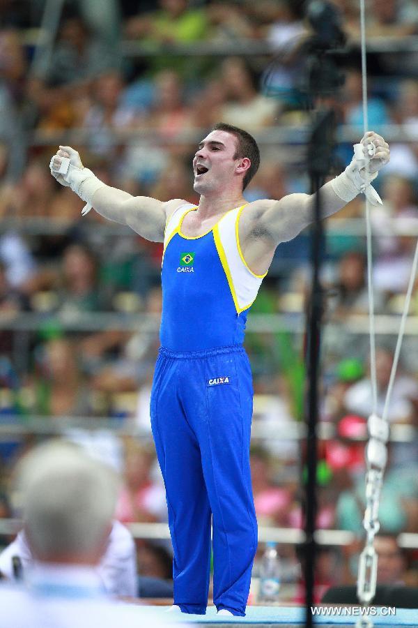 Arthur Nabarrete Zanetti of Brazil celebrates after the men's rings final at the 27th Summer Universiade in Kazan, Russia, July 10, 2013. Zanetti won the gold medal with 15.874 points. (Xinhua/Ren Yuan)