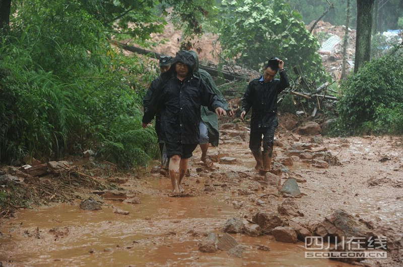 Rescuers clear the debris at flood-hit Zhongxin county, southwest China's Sichuan province on July 10, 2013. Rain-triggered mountain torrents and landslides buried 11 households, leaving two people dead and 21 missing. As of 9:45 p.m., 352 people stranded have been relocated to safe areas. (Photo by Fangwei/ scol.com.cn)
