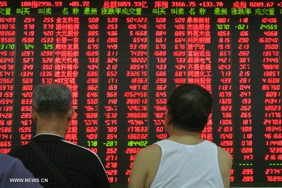 Investors look at a screen showing stock information at a trading hall of a securities firm in Beijing, capital of China, July 11, 2013. Chinese shares jumped to a three-week high Thursday over media reports that financing rules may be partially relaxed for real estate firms. The benchmark Shanghai Composite Index jumped 3.23 percent, or 64.86points, to end at 2,072.99. The Shenzhen Component Index soared 4.25 percent, or 333.52 points, to 8,184.77. (Xinhua/Li Xin)