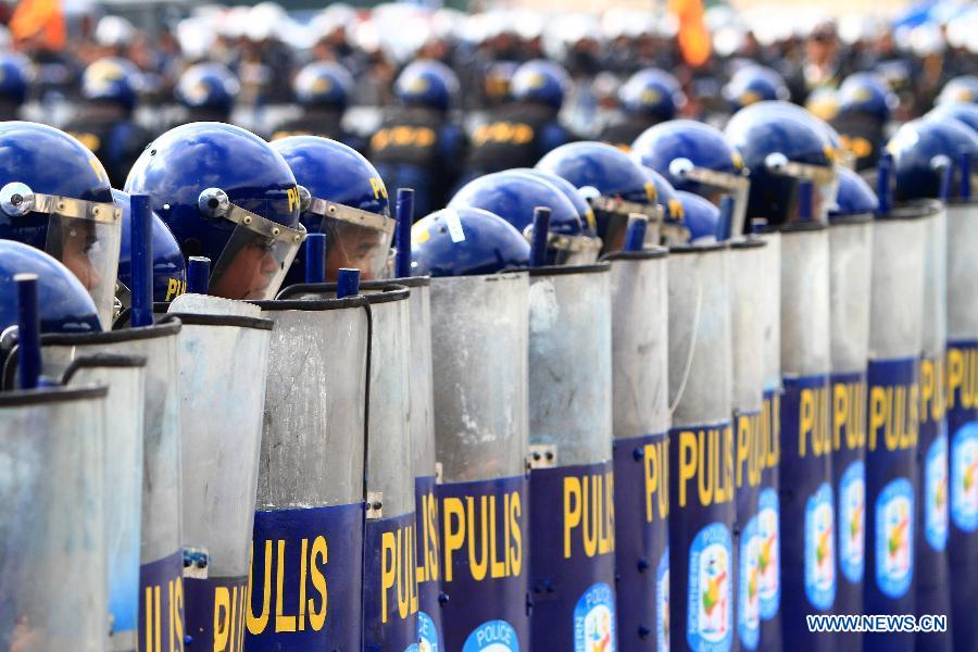 Members of the Civil Disturbance Management (CDM) of the Philippine National Police (PNP) stand in formation during the CDM Competition in Manila, the Philippines, July 11, 2013. The competition aimed to assess the effectiveness and efficiency of the CDM Units on the police operational procedures in handling civil disturbance. (Xinhua/Rouelle Umali)