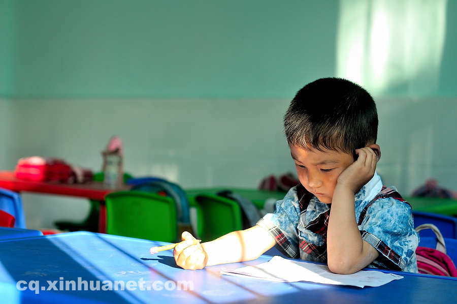 A pupil does her homework in the classroom. As a part of the eco-migration project which aims to help the poor overcome extreme difficulties, new houses and public schools were built in the settlement community in Lantian town, Chengkou county, southwest China’s Chongqing. (Xinhua Photo/ Li Xiangbo)