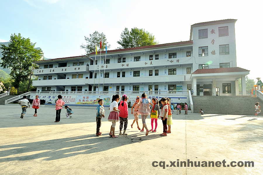 Pupils play on the playground after class. As a part of the eco-migration project which aims to help the poor overcome extreme difficulties, new houses and public schools were built in the settlement community in Lantian town, Chengkou county, southwest China’s Chongqing. (Xinhua Photo/ Li Xiangbo)