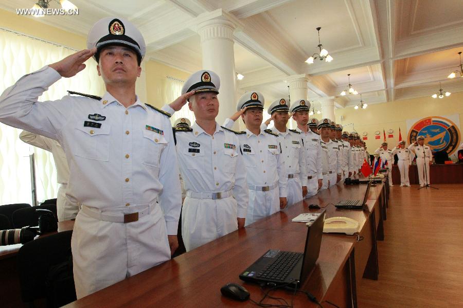 Naval officers from China and Russia salute at the closing ceremony of the joint naval drills in Vladivostok, Russia, July 11, 2013. Ding Yiping, deputy commander of the Chinese Navy and director of the "Joint Sea-2013" drill, announced the end of the joint naval drills here on Thursday. (Xinhua/Zha Chunming)