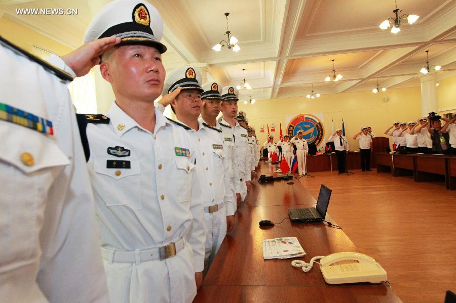 Naval officers from China and Russia salute at the closing ceremony of the joint naval drills in Vladivostok, Russia, July 11, 2013. Ding Yiping, deputy commander of the Chinese Navy and director of the "Joint Sea-2013" drill, announced the end of the joint naval drills here on Thursday. (Xinhua/Zha Chunming) 