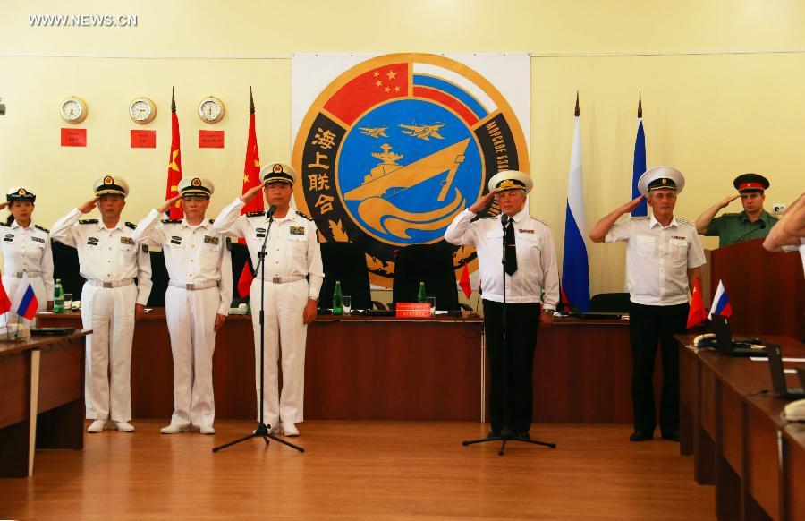 Naval officers from China and Russia salute at the closing ceremony of the joint naval drills in Vladivostok, Russia, July 11, 2013. Ding Yiping, deputy commander of the Chinese Navy and director of the "Joint Sea-2013" drill, announced the end of the joint naval drills here on Thursday. (Xinhua/Zha Chunming)