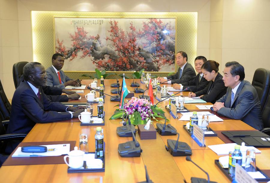 Chinese Foreign Minister Wang Yi (1st R) meets with Stephen Dhieu Dau (1st L), special envoy of South Sudan's President Salva Kiir in Beijing, capital of China, July 11, 2013. (Xinhua/Zhang Duo)