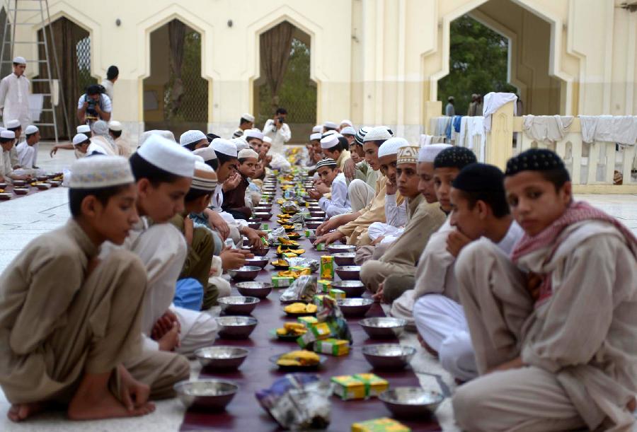 Pakistani Muslim devotees pray before breaking their fast at a mosque during the first day of the Muslim fasting month of Ramadan in northwest Pakistan's Peshawar on July 11, 2013. Iftar refers to the evening meal when Muslims break their fast during the holly month of Ramadan, a season of fasting and spiritual reflection. (Xinhua/Ahmad Sidique) 