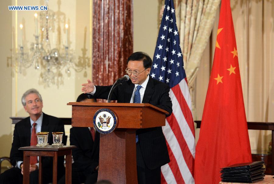 Yang Jiechi (R), Chinese State Councilor and special representative of Chinese President Xi Jinping, addresses a signing ceremony of China-U.S. EcoPartnership program in Washington, the United States, July 11, 2013. China and the United Sates on Thursday expanded their EcoPartnership program with the signing of six new partnerships to reduce greenhouse gases emissions and improve energy efficiency as well as to create jobs. (Xinhua/Wang Lei)