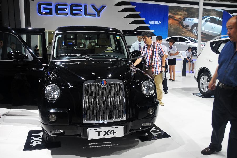 Visitors view a Geely vehicle at the 10th China Changchun International Automobile Expo in Changchun, capital of northeast China's Jilin Province, July 12, 2013. A total of 146 auto brands from 127 companies took part in the ten-day expo, which kicked off here on Friday. (Xinhua/Lin Hong)