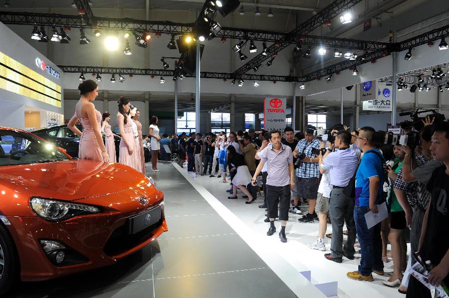 Models present vehicles at the 10th China Changchun International Automobile Expo in Changchun, capital of northeast China's Jilin Province, July 12, 2013. The ten-day expo kicked off here on Friday. (Xinhua/Xu Chang)