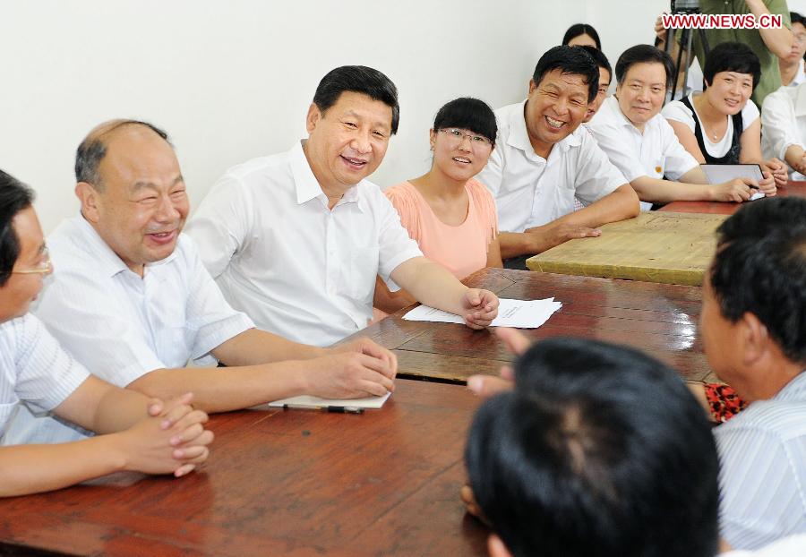 Chinese President Xi Jinping (3rd L) visits cadres and villagers at a community service center in Tayuanzhuang Village in Zhengding County, north China's Hebei Province. Xi made an inspection tour of Hebei Province from July 11 to 12. (Xinhua/Li Tao) 