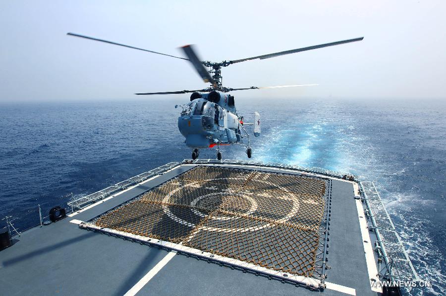 A Russian ship-borne helicopter takes off from a Chinese naval vessel during the "Joint Sea-2013" drill at Peter the Great Bay in Russia, July 9, 2013. Chinese and Russian warships carried out a variety of exercises including joint air defense, maritime supply, joint escort and the rescue of hijacked vessels during the second day of "Joint Sea-2013" drill. (Xinhua/Zha Chunming)