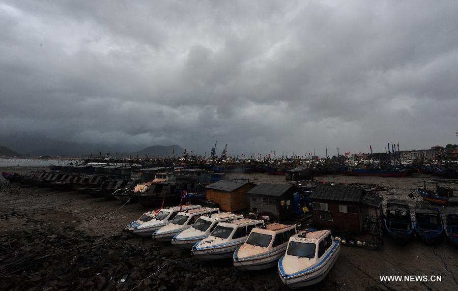 Clouds gather over the sky above a harbour in the Luoyuan County, southeast China's Fujian Province, July 13, 2013. The local meteorological authority issued a red alert against typhoon as Typhoon Soulik approaches, bringing strong wind and rainstorms to the region. (Xinhua/Wei Peiquan) 