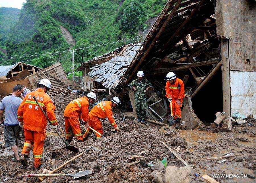 Rescuers search for missing people after mudslide in Hongxi Village of Pingwu County in Mianyang City, southwest China's Sichuan Province, July 12, 2013. Four people were injured and one was missing in a rain-triggered mudslide on Friday. Most of the houses in the village were buried in the mud. (Xinhua/Hu Yu)  