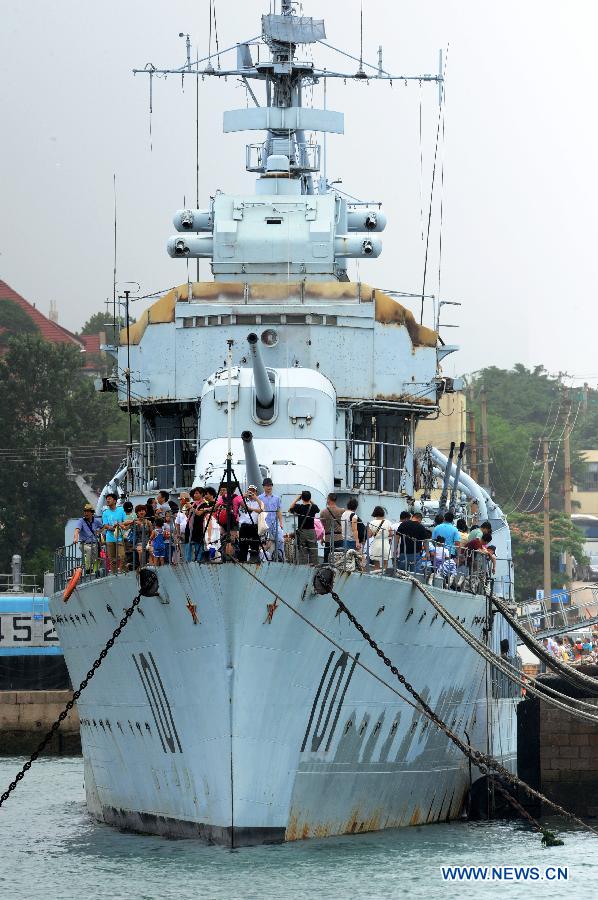 People visit the Anshan destroyer, the first destroyer of the Navy of the Chinese People's Liberation Army, in the Qingdao Naval Museum in Qingdao, east China's Shandong Province, July 14, 2013. Many parents took children to visit here as summer holiday began. (Xinhua/Li Ziheng) 