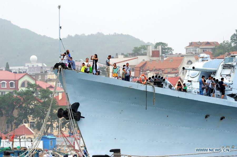 People visit the guided missile destroyer "Jinan", the first of its kind designed and made by China, in the Qingdao Naval Museum in Qingdao, east China's Shandong Province, July 14, 2013. Many parents took children to visit here as summer holiday began. (Xinhua/Li Ziheng) 