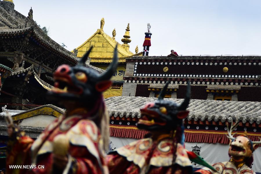 Buddhists wearing masks attend a ceremony expressing stories of Gods and ghosts in Tibetan Buddhism at the Taer (Gumbum) Monastery in Huangzhong County of Xining, capital of northwest China's Qinghai Province, July 14, 2013. The ceremony, which is called "Tiao Qian" in Chinese, was held on Sunday here at the monastery, the birth place of Tsongkhapa, founder of the Geluk school of Tibetan Buddhism. (Xinhua/Wu Gang)