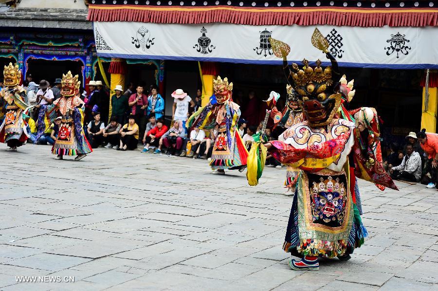 Buddhists wearing masks attend a ceremony expressing stories of Gods and ghosts in Tibetan Buddhism at the Taer Monastery in Huangzhong County of Xining, capital of northwest China's Qinghai Province, July 14, 2013. The ceremony, which is called "Tiao Qian" in Chinese, was held on Sunday here at the monastery, the birth place of Tsongkhapa, founder of the Geluk school of Tibetan Buddhism. (Xinhua/Wu Gang)