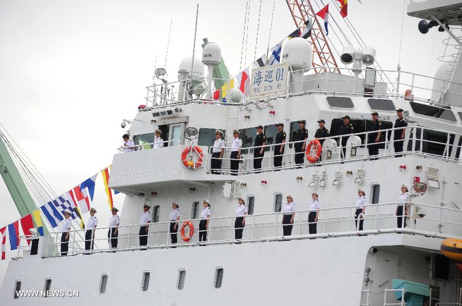 Crew members stand on the deck of China's patrol and search-and-rescue vessel "Haixun 01" at the Tanjung Priok port in Jakarta, Indonesia, July 14, 2013. China's patrol and search-and-rescue vessel "Haixun 01" arrived at Jakarta on Sunday, commencing its goodwill visit to Indonesia for the next four days. (Xinhua/Zulkarnain)
