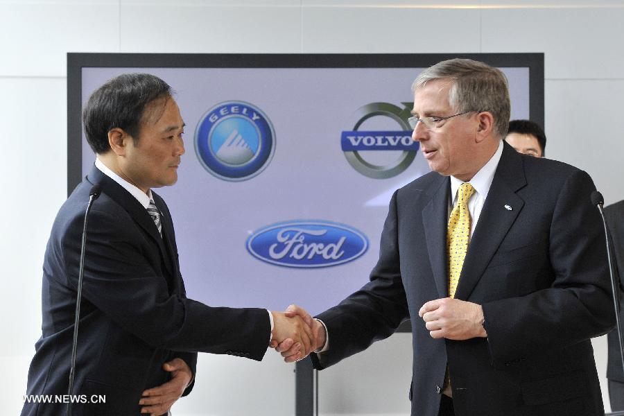 File photo taken on March 28, 2010 shows Geely Chairman Li Shufu (L) shaking hands with CFO of Ford Motor Company, Lewis Booth after signing a deal in Goteborg of Sweden.  (Xinhua)