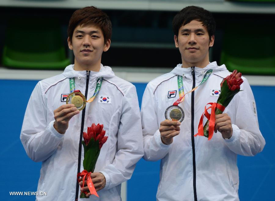 Lee Yong Dae (L) and Ko Sung Hyun of South Korea pose during the awarding ceremony after the men's doubles final match of badminton event against Ivan Sozonov and Vladimir Ivanov of Russia at the 27th Summer Universiade in Kazan, Russia, July 11, 2013. Lee Yong Dae and Ko Sung Hyun won the gold medal with 3-0. (Xinhua/Kong Hui)