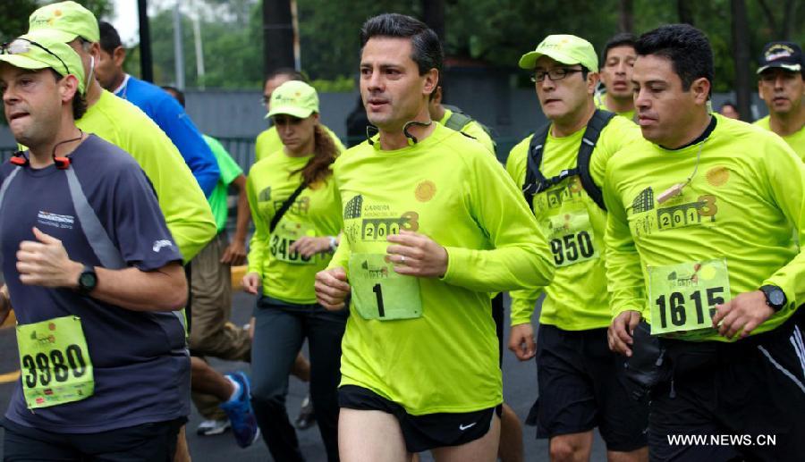 Image provided by the Presidency of Mexico shows Mexican President Enrique Pena Nieto (C) participating in the race organized by the Presidential General Staff in the Chapultepec Forest, in Mexico City, capital of Mexico, on July 13, 2013. (Xinhua/Presidency of Mexico)