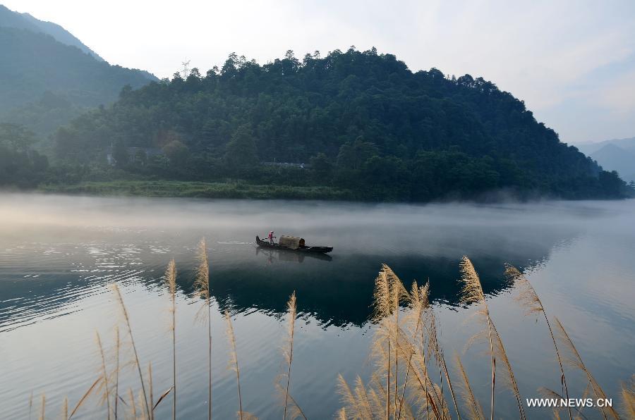 A fisherman fishes on the Xiaodongjiang River in Zixing City, central China's Hunan Province, July 7, 2013. (Xinhua/He Maofeng)