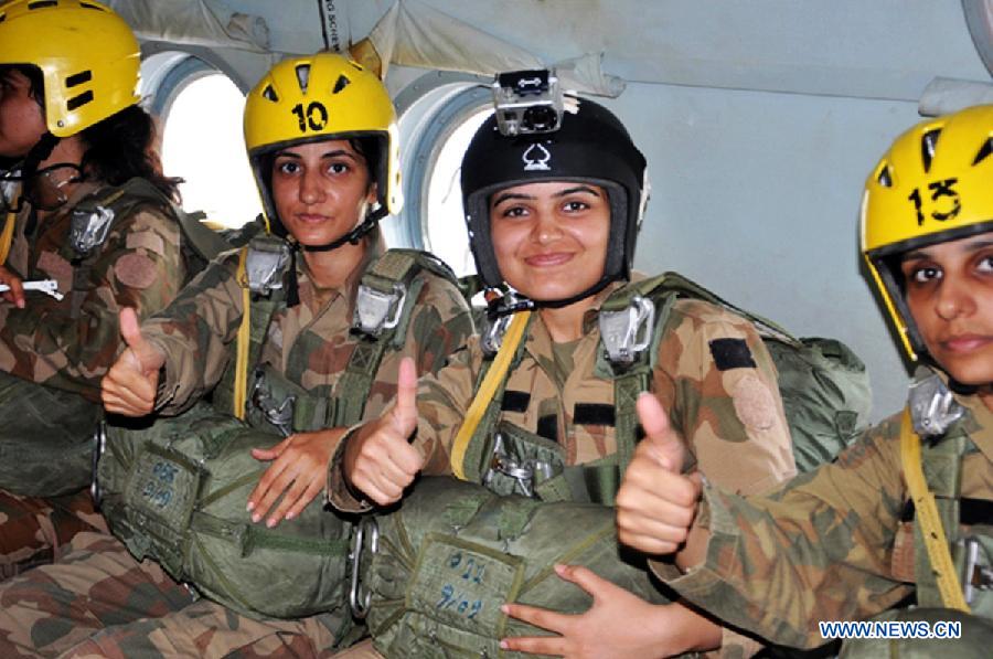 Photo released by Pakistan's Inter Services Public Relations (ISPR) office on July 14, 2013 shows Pakistan Army lady officers gesturing before jumping out from a helicopter in northwest Pakistan's Peshawar. A total of 24 lady officers of Pakistan Army successfully completed 3 weeks of Basic Air Borne course at Para Training School in Peshawar. (Xinhua/ISPR)