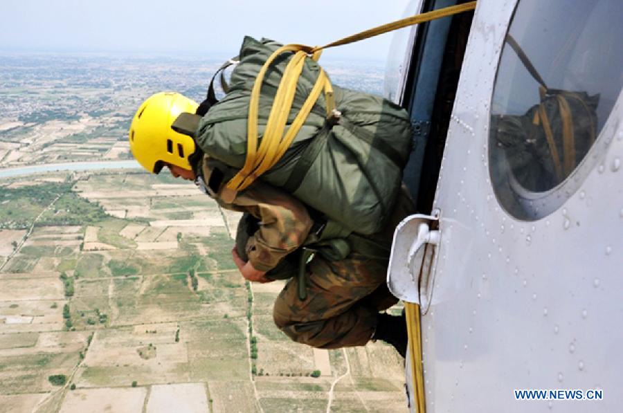 Photo released by Pakistan's Inter Services Public Relations (ISPR) office on July 14, 2013 shows a Pakistan Army lady officer jumping out from a helicopter in northwest Pakistan's Peshawar. A total of 24 lady officers of Pakistan Army successfully completed 3 weeks of Basic Air Borne course at Para Training School in Peshawar. (Xinhua/ISPR)