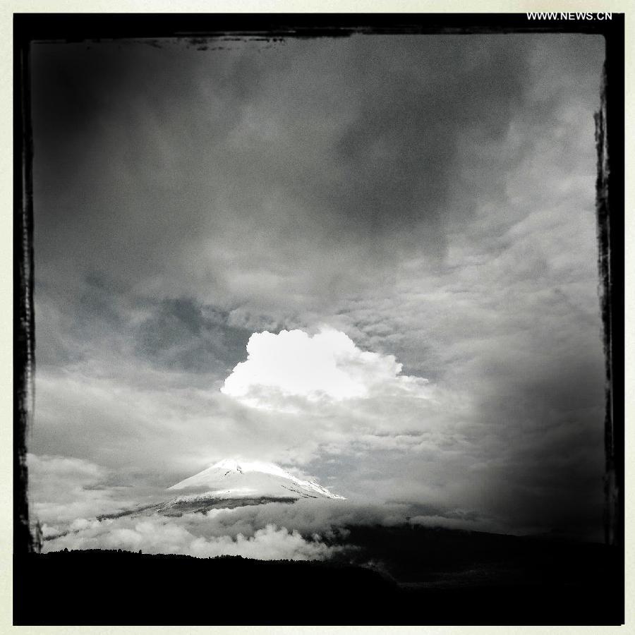 Image taken on July 13, 2013 using an Iphone 4S' "Hipstamatic" app shows the Popocatepetl volcano, in Santiago Xalitzintla, in the San Nicolas de los Ranchos municipality, in the state of Puebla, in the center of Mexico. (Xinhua/Guillermo Arias)
