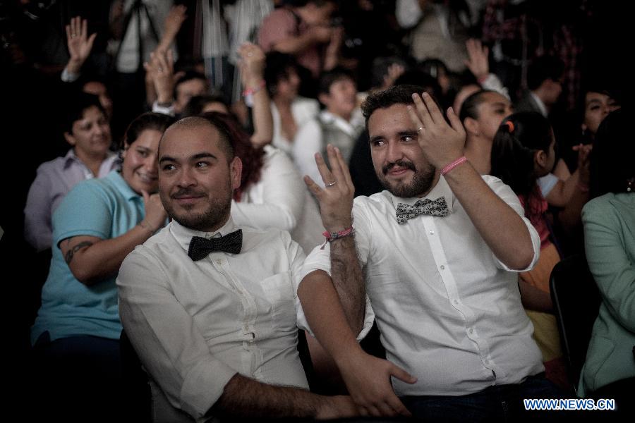A same sex couple show their wedding rings during a collective gay wedding in Mexico City, capital of Mexico, on July 14, 2013. The collective gay wedding celebrated in Mexico's capital, was presided by Mexico's City Head of Government, Miguel Angel Mancera, according to the local press. (Xinhua/Pedro Mera)