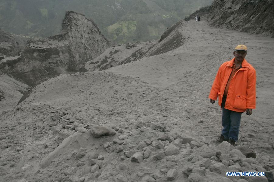 A man observes a path covered with ashes near the Tungurahua volcano, in the Tungurahua province, Ecuador, on July 14, 2013. The Ecuador's Risk Management Secretariat, declared an orange alert in some locations near the volcano where several families have been evacuated to the shelters prepared for the emergency, according to local press. (Xinhua/Str)