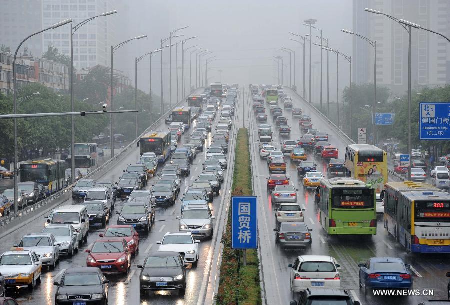 Cars are stranded in a traffic jam in Beijing, capital of China, July 15, 2013. Beijing's meteorologic center on Monday issued a yellow alert for rainstorm, as the lasting rainfall affected Beijing's traffic. (Xinhua/Luo Xiaoguang) 