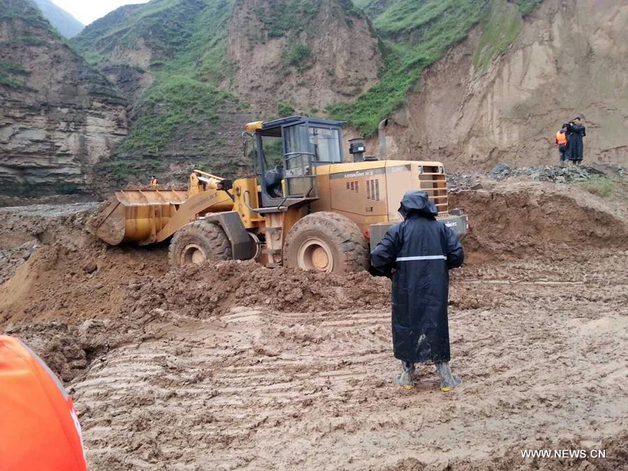 Photo taken on July 15, 2013 shows a collapsed road destroyed by a rain-triggered floods in Fanjiachuan Village of Qingyang City, northwest China's Gansu Province. Two people were killed, one was injured and six others were reported missing in the rain-triggered floods. Rescue work is underway. (Xinhua/Li Pengbo)