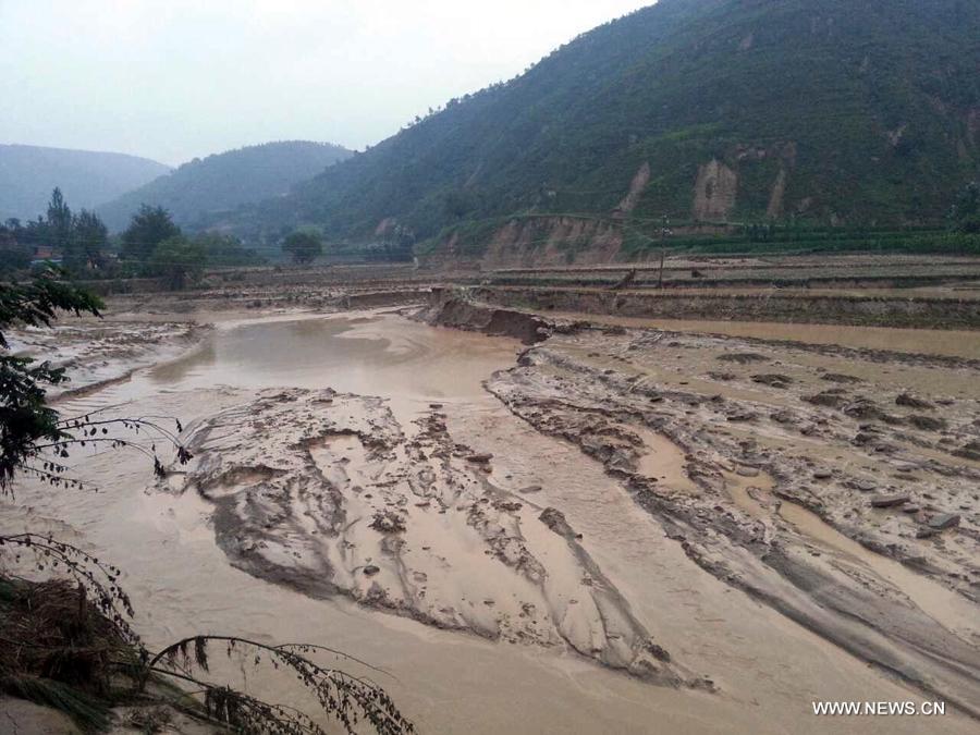 Photo taken on July 15, 2013 shows a farmland destroyed by a rain-triggered floods in Fanjiachuan Village of Qingyang City, northwest China's Gansu Province. Two people were killed, one was injured and six others were reported missing in the rain-triggered floods. Rescue work is underway. (Xinhua/Li Pengbo) 