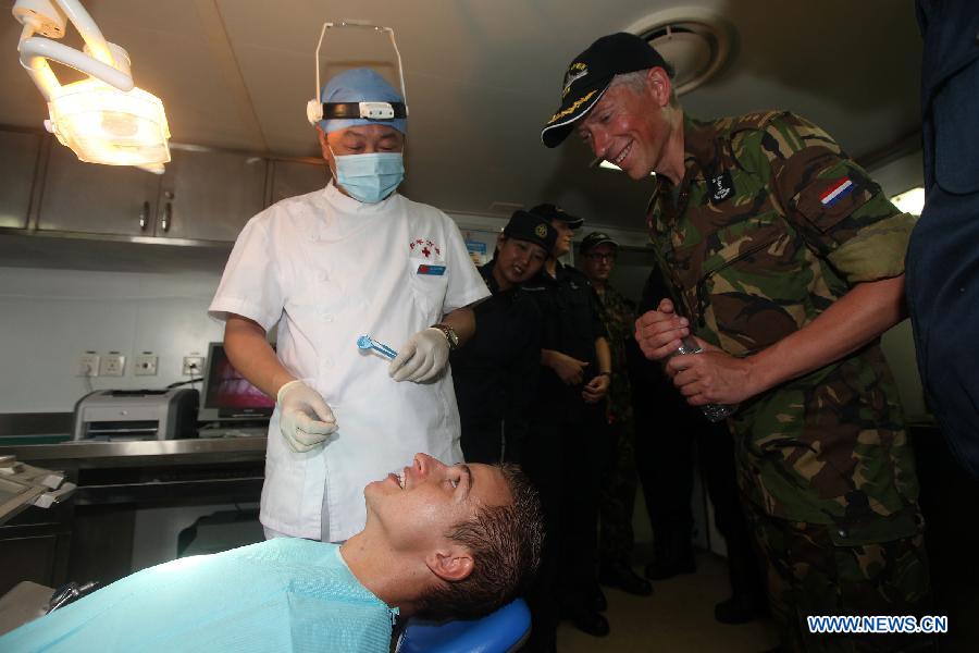 A sailor from Netherlands' Van Speijk vessel receives dental operation on Chinese People's Liberation Army Navy hospital ship "Peace Ark" in Gulf od Aden, July 14, 2013. It was the first time PLA Navy hospital ship "Peace Ark" provided medical treatment for foreign soldiers during its 10-day mission to Gulf of Aden. (Xinhua/Ju Zhenhua) 