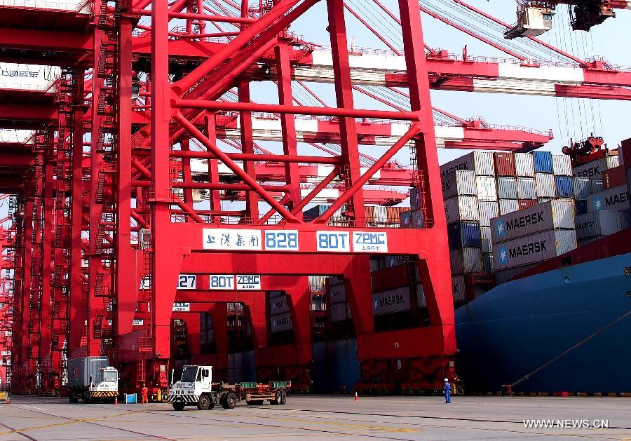 A container vessel is seen in handling operation in Yangshan Deep-water Port in east China's Shanghai municipality, May 19, 2013. China's gross domestic product (GDP) totaled 24.8 trillion yuan (4 trillion U.S. dollars) in the first half of 2013, with the growth at 7.6 percent, which is in line with market expectations and was above the government's full-year target of 7.5 percent, data from China's National Bureau of Statistics (NBS) showed on July 15, 2013.(Xinhua/Chen Fei)