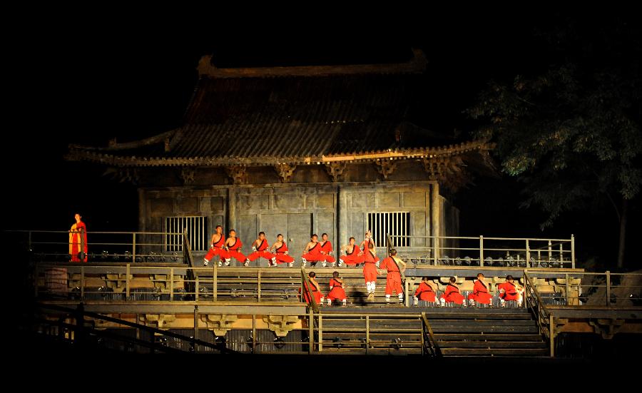 Actors perform in the music ritual in Zhengzhou, capital of central China's Henan Province, July 14, 2013. The real scene show "Shaolin Zen Music Ritual" has run for more than 1,600 performances since its premiere in May, 2007. The music ritual was shown on the natural stage of the Songshan Mountain to present a rhythm combined with natural sounds and the "Zen Music". (Xinhua/Zhu Xiang)