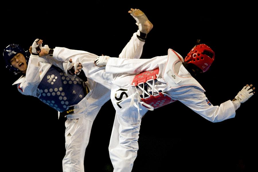 Rafiet Mesiam (R) from Iceland competes against Stevanes Ariosusenosen (L) from Indonesia in the 58 kg men's category of the Taekwondo World Championship of the World Taekwondo Federation (WTF), in the Exposition and Covention Center of Puebla, in Puebla, Mexico, on July 15, 2013. (Xinhua/Guillermo Arias)  