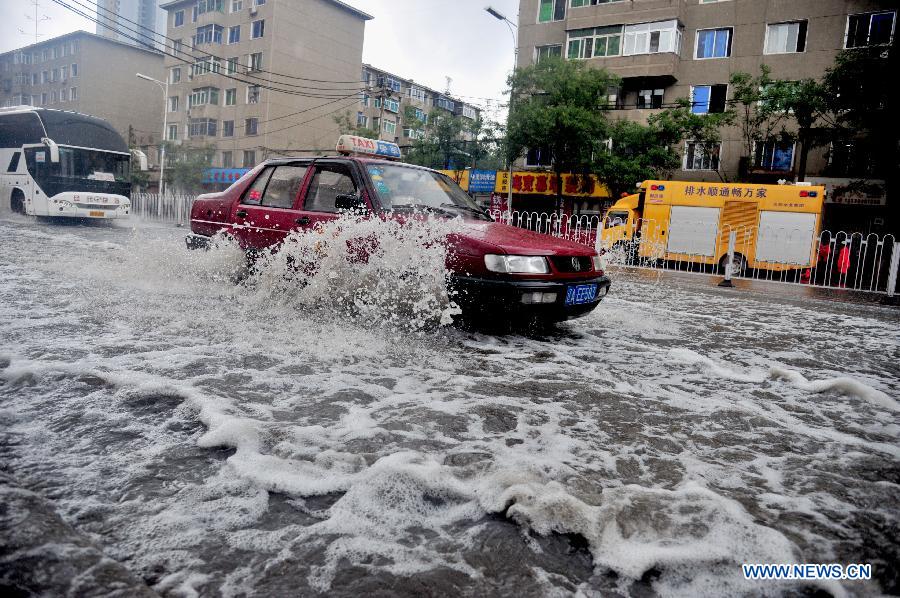 Cars drive on a flooded road in Shenyang, capital of northeast China's Liaoning Province, July 16, 2013. Shenyang was hit by a rainstorm on Tuesday. (Xinhua/Zhang Wenkui) 