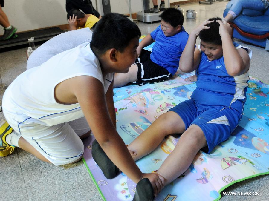 Children exercise at a summer camp against childhood overweight or obesity in Zhengzhou, capital of central China's Henan Province, July 16, 2013. Coached by doctors and counselors from local children's hospital, 37 children participated in the nearly monthlong camp to lose weight. (Xinhua/Li Bo) 