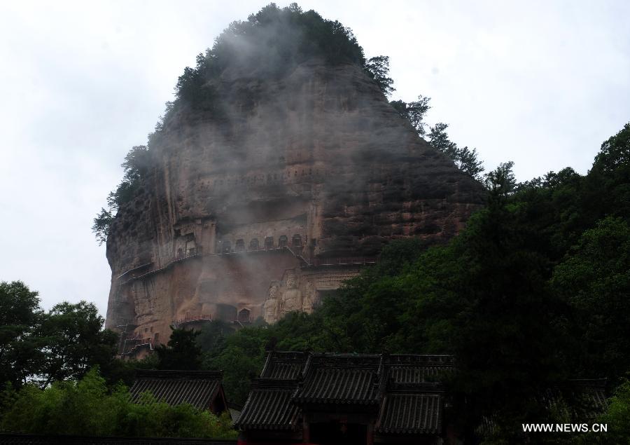 Photo taken on July 15, 2013 shows the scenery at the Maiji Mountain Grottoes in Tianshui, northwest China's Gansu Province. After protection and preparation, the Maiji Mountain Grottoes, the fourth largest grottoes in China and known as the "Oriental Sculpture Museum", has been ready for the application for status on the World Heritage List in 2014, as a part of the application program of the 2,000-year-old Silk Road which China works with Kazakstan and Kyrgyzstan and was officially submitted to the United Nations Educational, Scientific and Cultural Organization (UNESCO) in January of 2013. China has altogether 22 historical sites in this application program, including seven in Xinjiang, five in Gansu, six in Shaanxi and four in Henan. (Xinhua/Nie Jianjiang) 