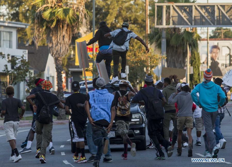 Protesters take part in a demonstration to protest George Zimmerman's acquittal in the shooting death of Florida teen Trayvon Martin, in Los Angeles, California, July, 15, 2013.A Jury in U.S. state Florida on July 13 acquitted George Zimmerman, who shot and killed Seventeen-year-old African American teenager Trayvon Martin on Feb. 26, 2012, in a case which sparked heated debate on race and guns. (Xinhua/Zhao Hanrong)
