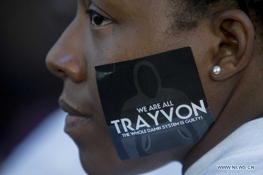 A protester is seen with a sticker showing the name of Trayvon Martin on the face during a demonstration to protest George Zimmerman's acquittal in the shooting death of Florida teen Trayvon Martin, in Los Angeles, California, July, 15, 2013.A Jury in U.S. state Florida on July 13 acquitted George Zimmerman, who shot and killed Seventeen-year-old African American teenager Trayvon Martin on Feb. 26, 2012, in a case which sparked heated debate on race and guns. (Xinhua/Zhao Hanrong)